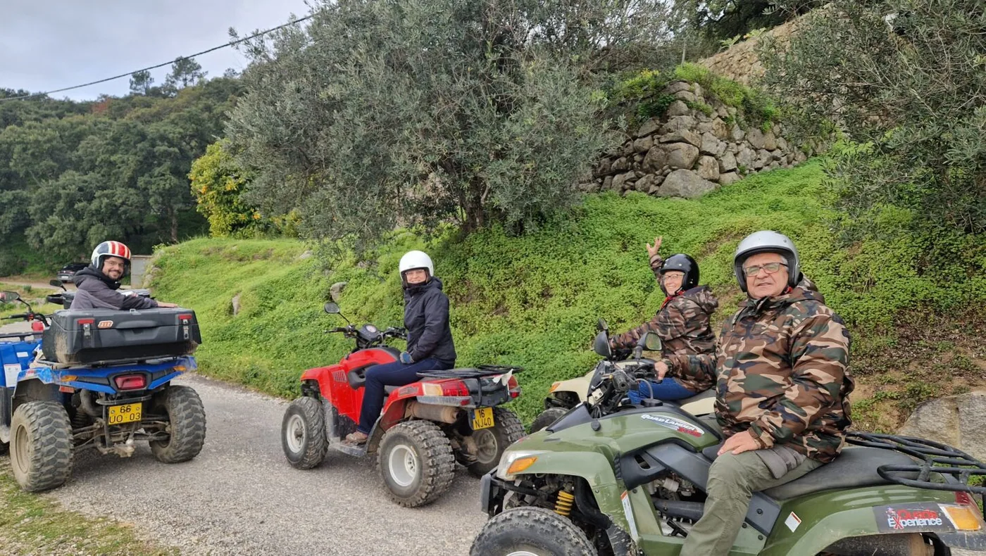 A guided quad group riding through green Monchique countryside