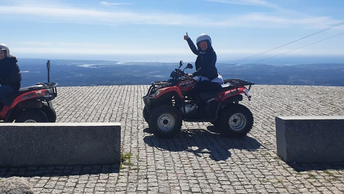 Quad rider overlooking the Algarve coast from a summit