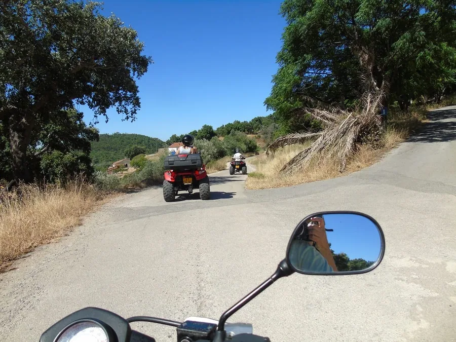 Quads following a winding mountain road